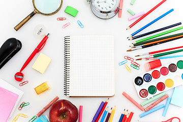 Image showing School set with notebooks, pencils, brush, scissors and apple on white background