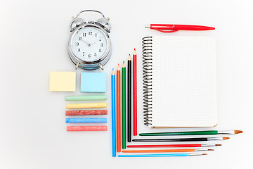 Image showing School set with notebooks, pencils, brush, scissors and apple on white background