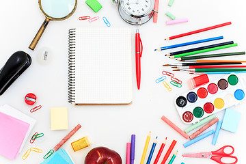 Image showing School set with notebooks, pencils, brush, scissors and apple on white background