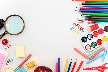 Image showing School set with notebooks, pencils, brush, scissors and apple on white background