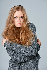 Image showing Woman muffling in warm knitted cardigan