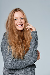 Image showing Woman muffling in warm knitted cardigan