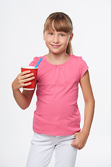 Image showing Little child girl holding a drink in disposable paper cup