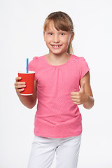 Image showing Little child girl holding a drink in disposable paper cup