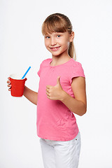 Image showing Little child girl holding a drink in disposable paper cup