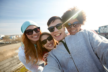 Image showing group of happy friends taking selfie on street