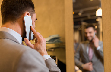 Image showing close up of man calling on cellphone at store