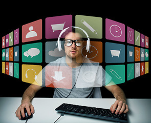 Image showing man in headset with computer and icons on screen