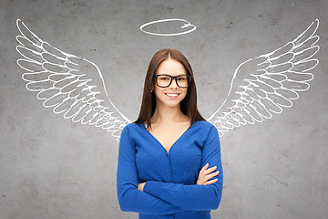 Image showing happy businesswoman with angel wings and nimbus