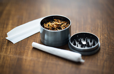 Image showing close up of marijuana joint and herb grinder