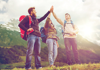 Image showing group of smiling friends with backpacks hiking