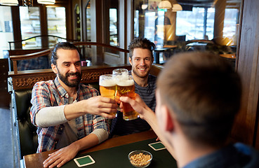 Image showing happy male friends drinking beer at bar or pub