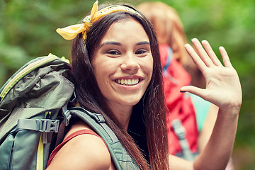 Image showing group of smiling friends with backpacks hiking