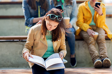 Image showing high school student girl reading book outdoors