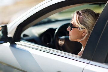 Image showing happy teenage girl or young woman in car