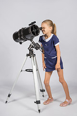 Image showing Young funny astronomer looks through the eyepiece of the telescope