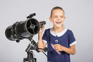 Image showing The young astronomer happily standing on the starry sky