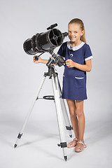 Image showing The young astronomer sets up a telescope and looked into the frame