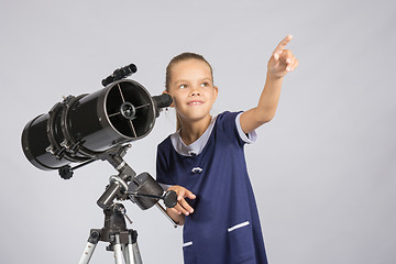 Image showing The young astronomer pointing at the starry sky