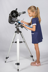 Image showing Young Astronomer writes the results of observations in the Documents folder