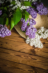 Image showing Bouquet of lilacs and a straw hat, close-up