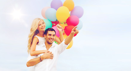 Image showing couple with colorful balloons at sea side