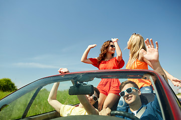 Image showing happy friends driving in cabriolet car