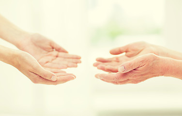 Image showing close up of senior and young woman hands