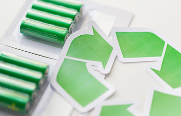 Image showing close up of batteries and green recycling symbol