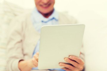 Image showing close up of senior woman with tablet pc at home