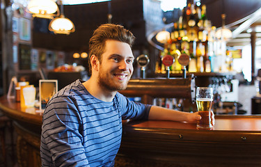 Image showing happy man drinking beer at bar or pub