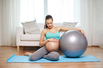 Image showing happy pregnant woman with fitball at home