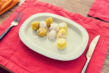 Image showing plate of spring rolls with rice on table