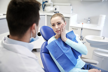 Image showing male dentist with woman patient at clinic