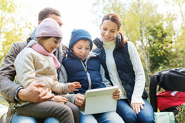 Image showing happy family with tablet pc and backpacks at camp