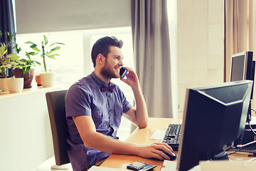 Image showing happy creative male worker calling on smarphone