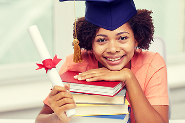 Image showing happy african bachelor girl with books and diploma