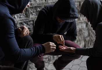 Image showing close up of addicts using drug pills