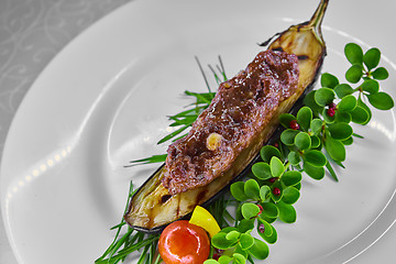 Image showing Kebab on grilled eggplant decorated with greens