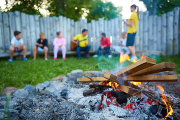 Image showing happy kids having fun around camp fire