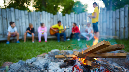 Image showing happy kids having fun around camp fire