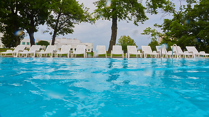 Image showing wimming pool with blue water and empty sunbed