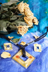 Image showing Dried bunch of yellow roses and modern necklace