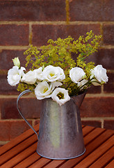 Image showing Floral arrangement of white prairie gentians in a vintage jug