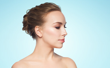 Image showing beautiful young woman face over blue background