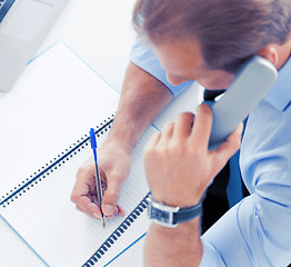 Image showing handsome businessman talking on the phone