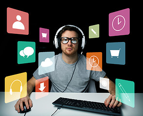 Image showing man in headset with computer and icons on screen