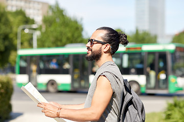 Image showing man traveling with backpack and map in city