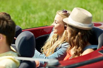 Image showing happy friends driving in cabriolet car