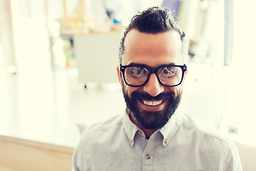 Image showing smiling man with eyeglasses and beard at office